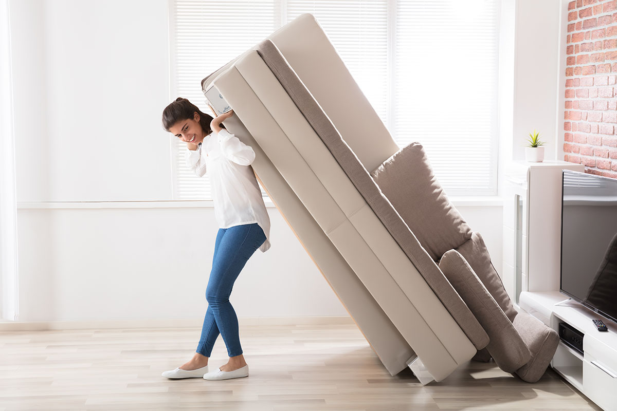 Woman Moving sofa | Carpet Direct Flooring