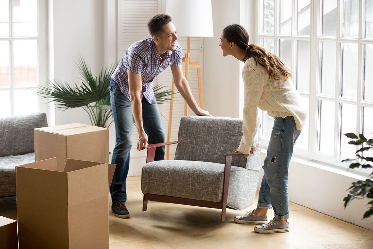 Couple moving furniture | Carpet Direct Flooring