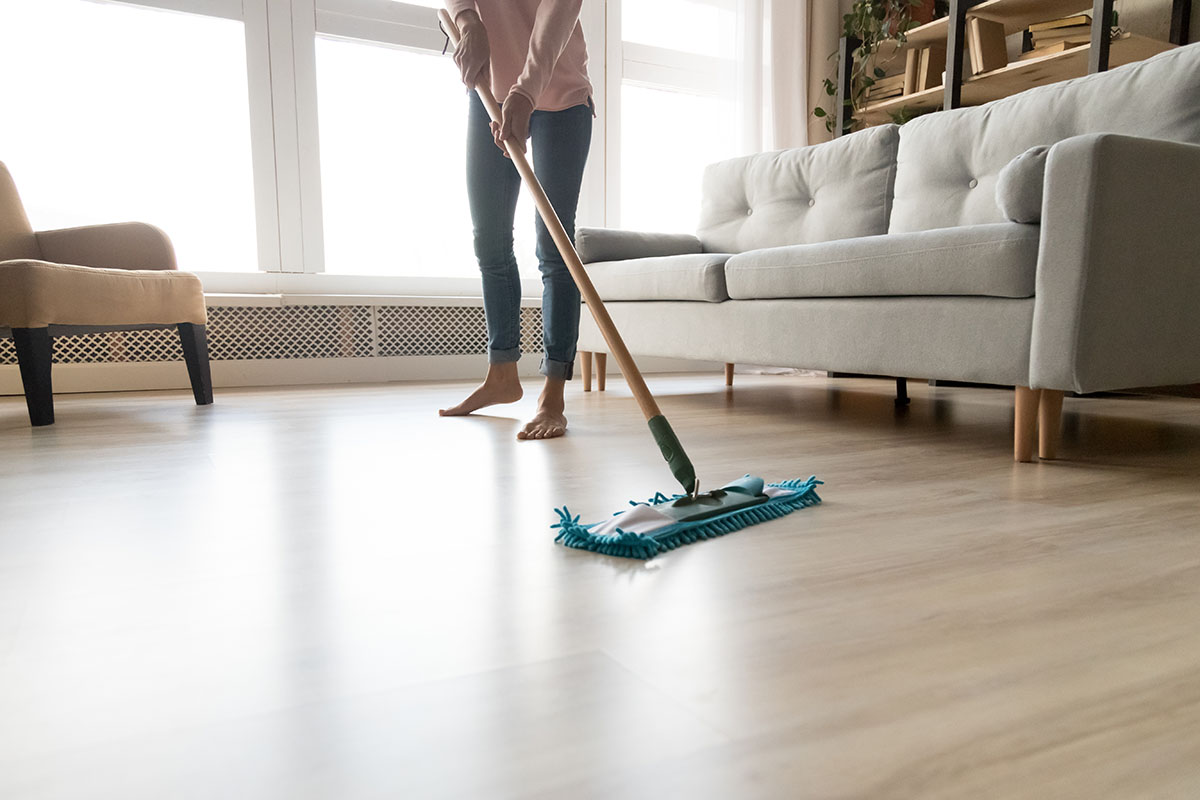 Lady cleaning laminate flooring | Carpet Direct Flooring