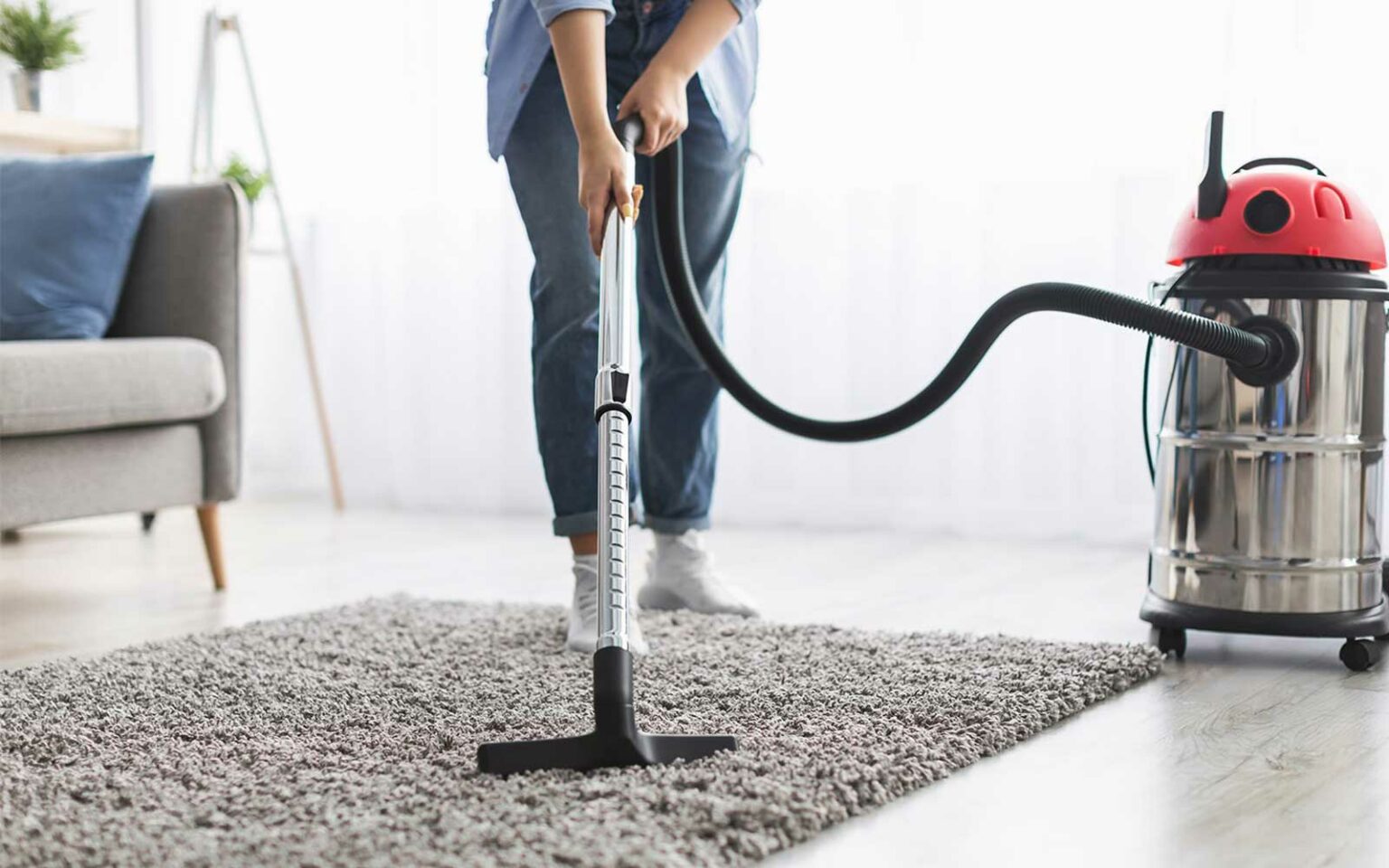 Lady vacuuming rug | Carpet Direct Flooring