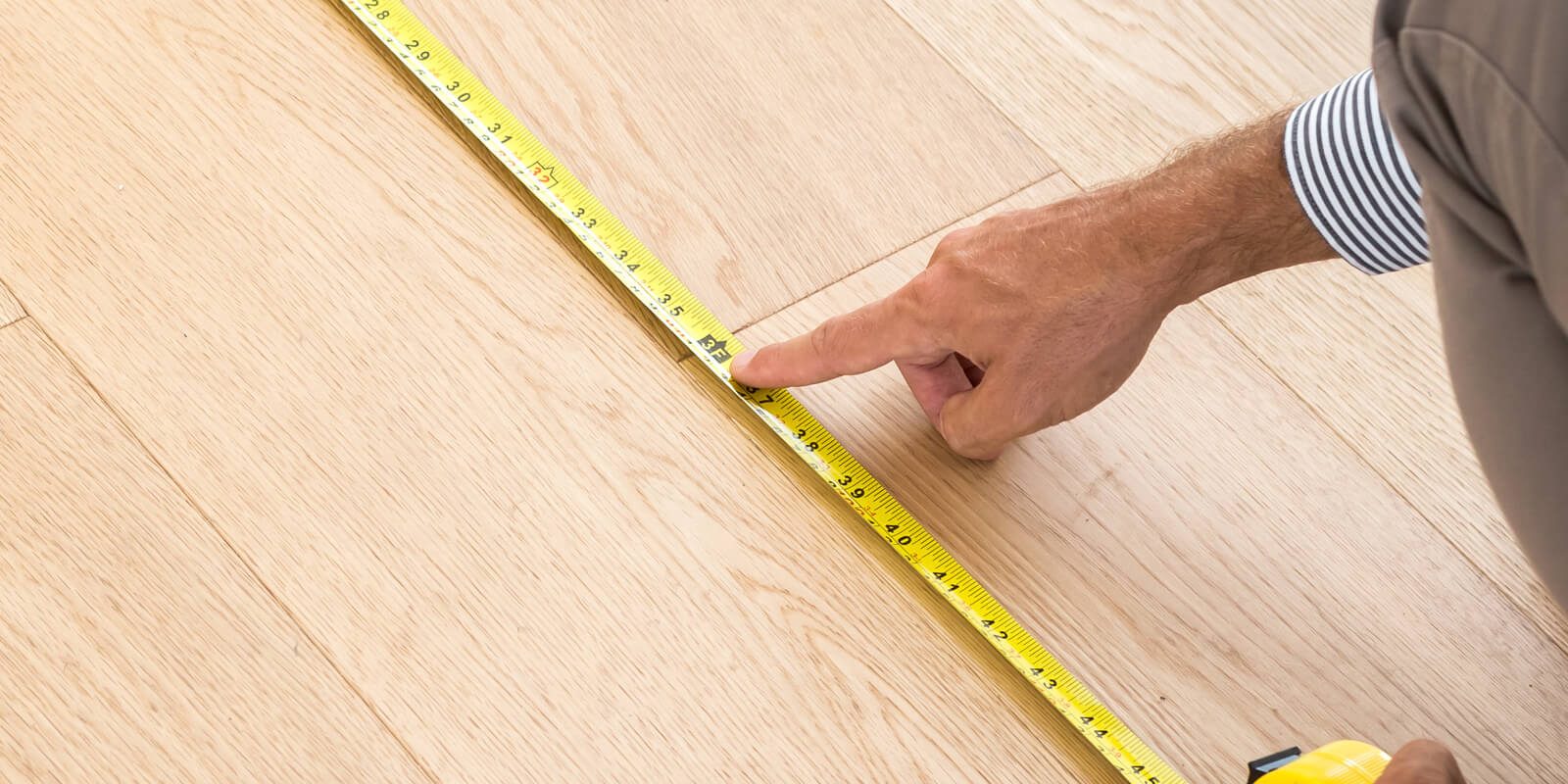 Man measuring floor | Carpet Direct Flooring