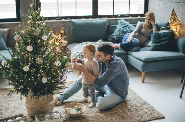 dad and daughter decorating Christmas tree | Carpet Direct Flooring